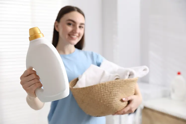 Parent selecting laundry detergent for baby clothes